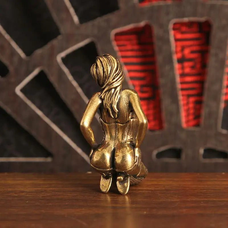 Rear view of the antique brass-tone kneeling woman mini sculpture
