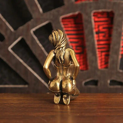 Rear view of the antique brass-tone kneeling woman mini sculpture