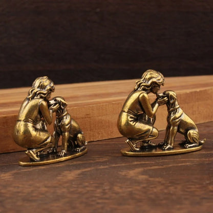 Two miniature lady and dog figurines arranged as a decorative set