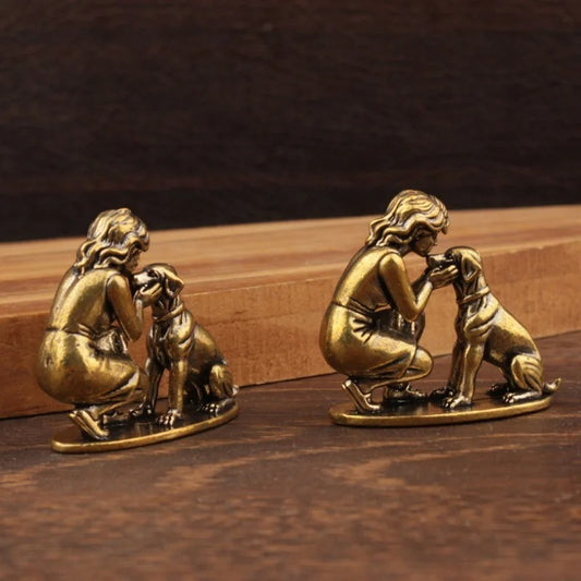 Two miniature lady and dog figurines arranged as a decorative set